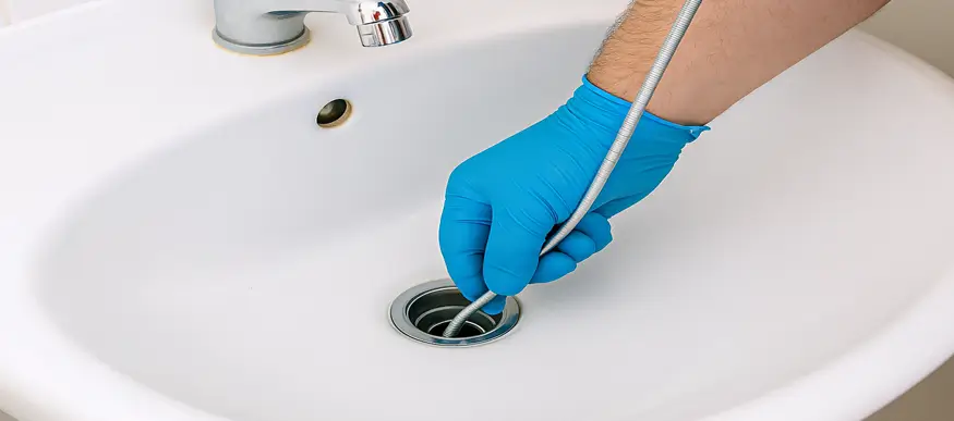 Plumber cleaning drain in Katy TX